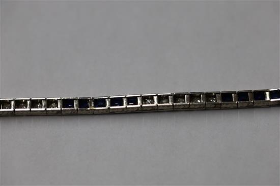 A 1920s 18ct white gold, sapphire and diamond set line bracelet, in original fitted Charles Packer & Co Ltd box.